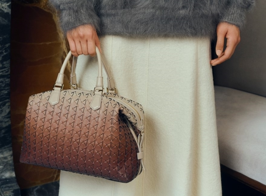 A woman holding brown ombre Serapian bag
